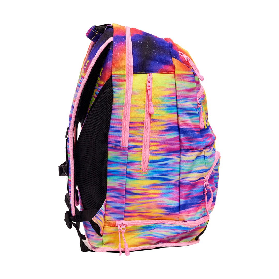 Side view of the a multicoloured sunset print Funkita Darkinjung Sunset Backpack showing multiple compartments and padded shoulder straps.