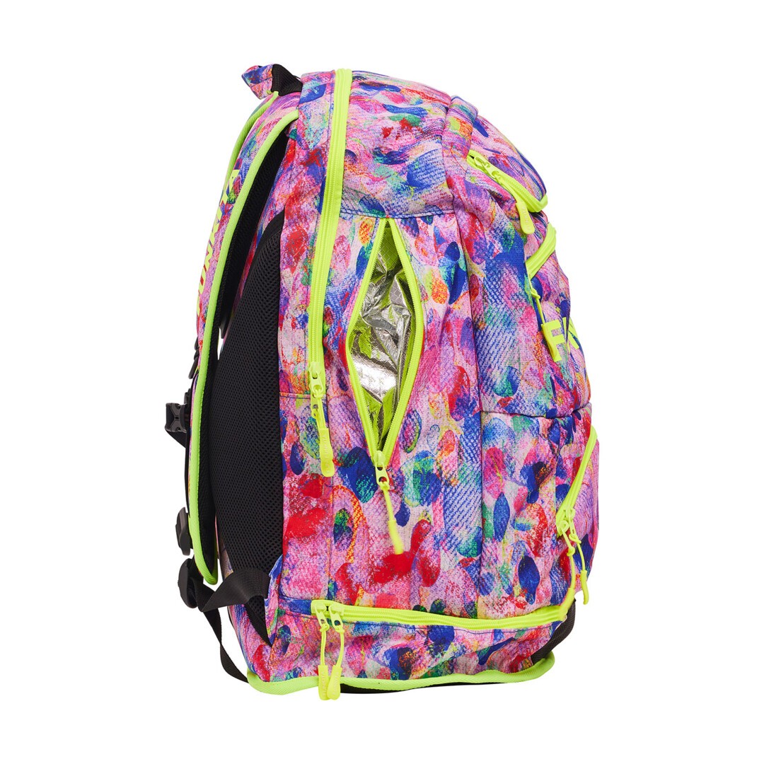 Side view of a multicolored floral pattern Funkita backpack with bright accents and multiple compartments, featuring padded shoulder straps.