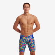 A man wearing multicolored Funky Trunks Choppy Water jammers with Funky Trunks brand logo on the legs.