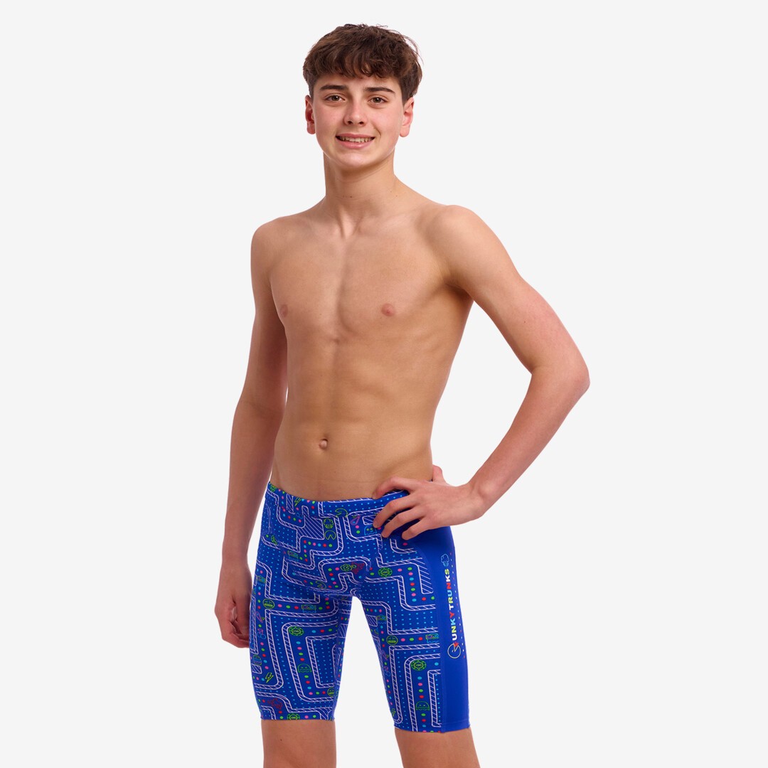 A boy wearing multicoloured Funky Trunks Much Munchies Boy's Training jammers.
