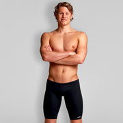 A man standing with his arms crossed wearing black Funky Trunks jammers.