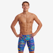 A man wearing multicolored Stir Crazy Funky Trunks jammers