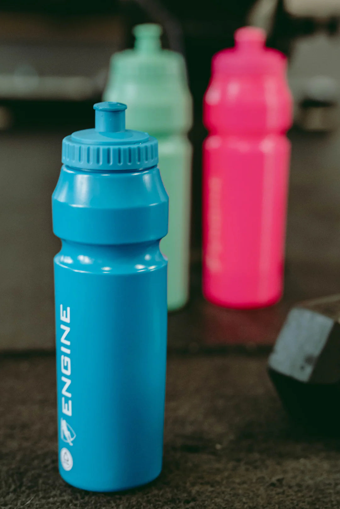 Blue water bottle with 'Engine' branding on a blurred background