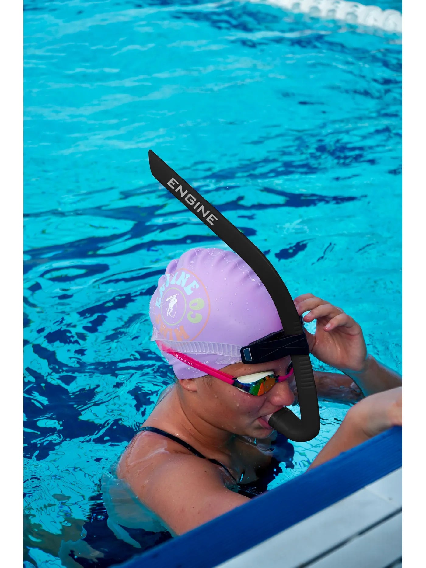 Swimmer in water wearing a black 'Engine' front snorkel
