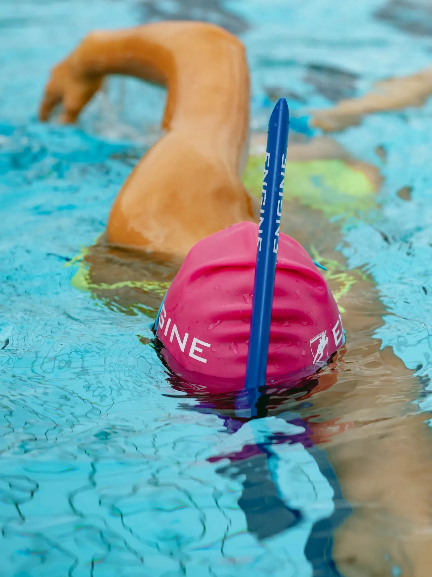 Male swimming in water wearing a blue 'Engine' front snorkel