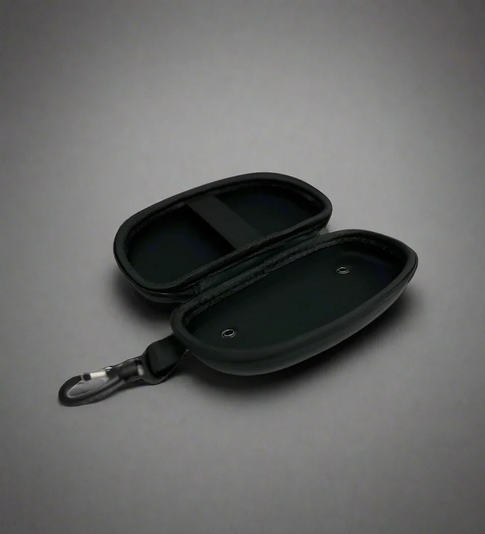 Open view of black goggle case with 'ENGINE' branding on and black trim