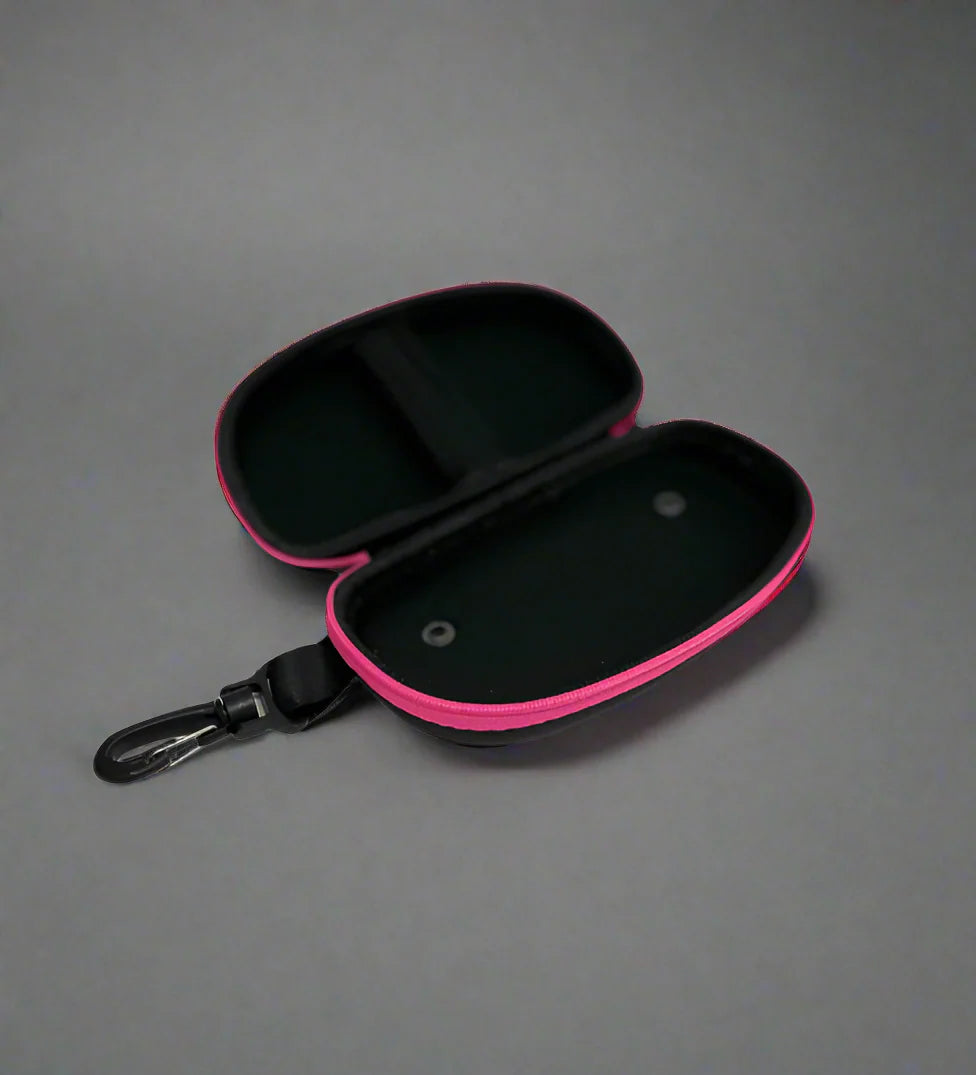 Open view of black goggle case with 'ENGINE' branding on and pink trim
