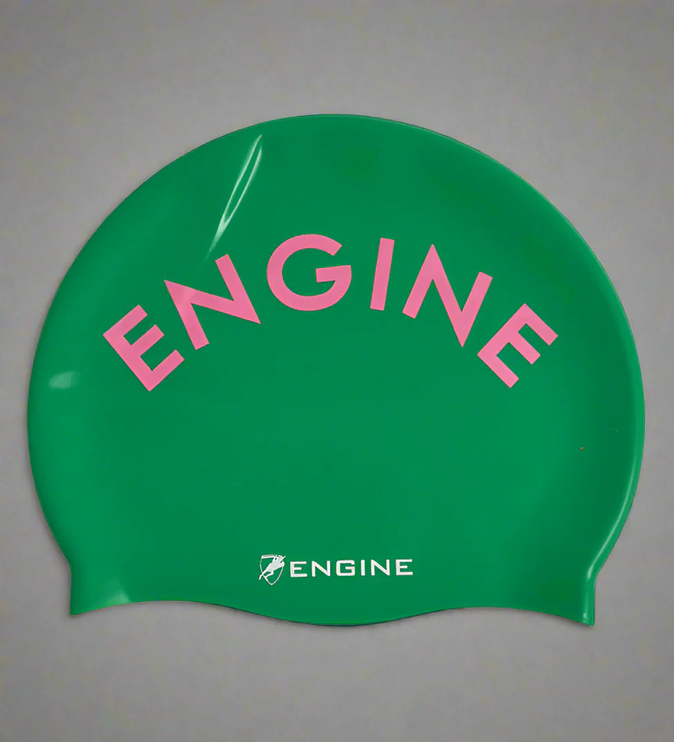 Apple green swim cap with pink 'ENGINE' text on a grey background