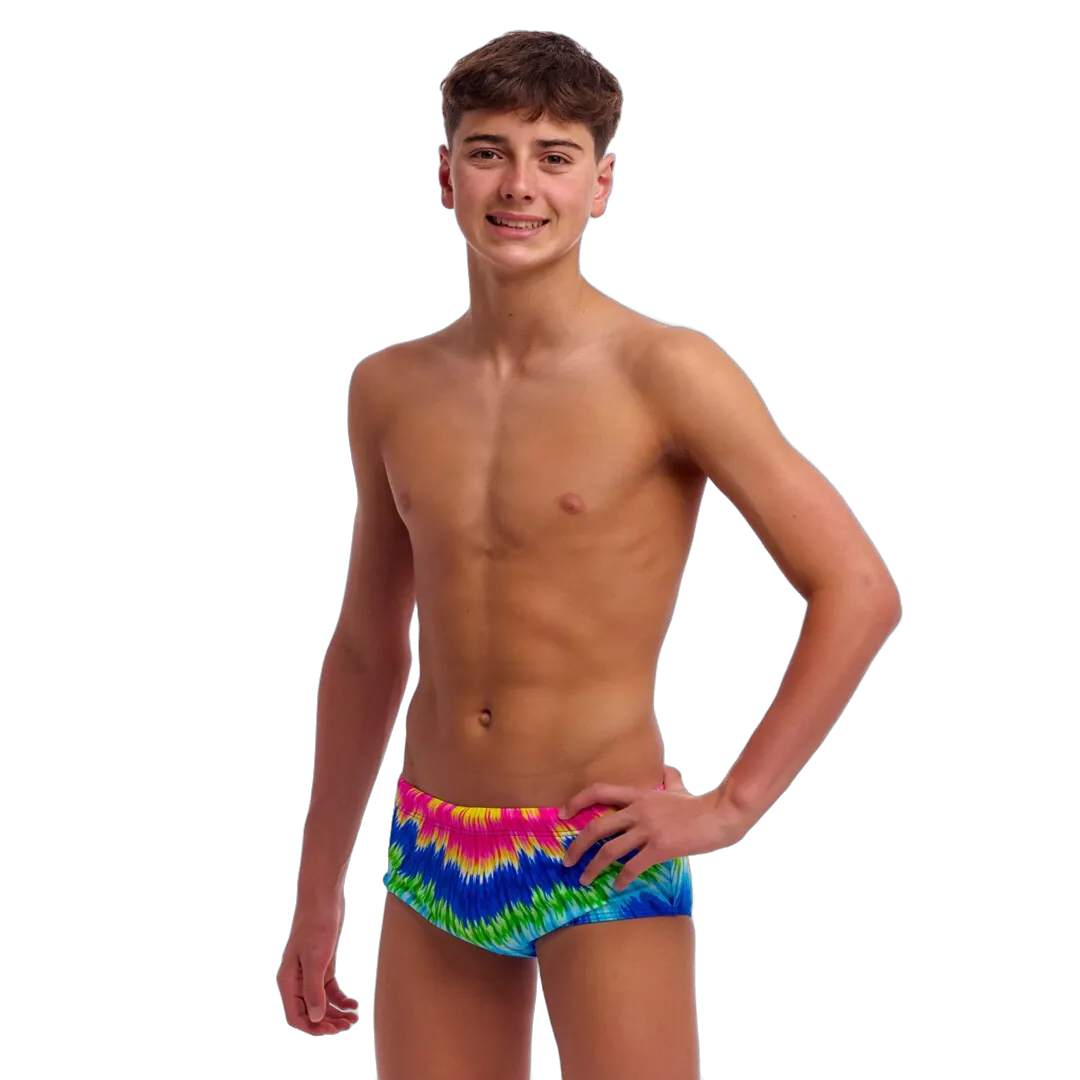 Boy wearing colourful tie-dye swimming trunks