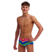 Boy wearing colourful tie-dye swimming trunks