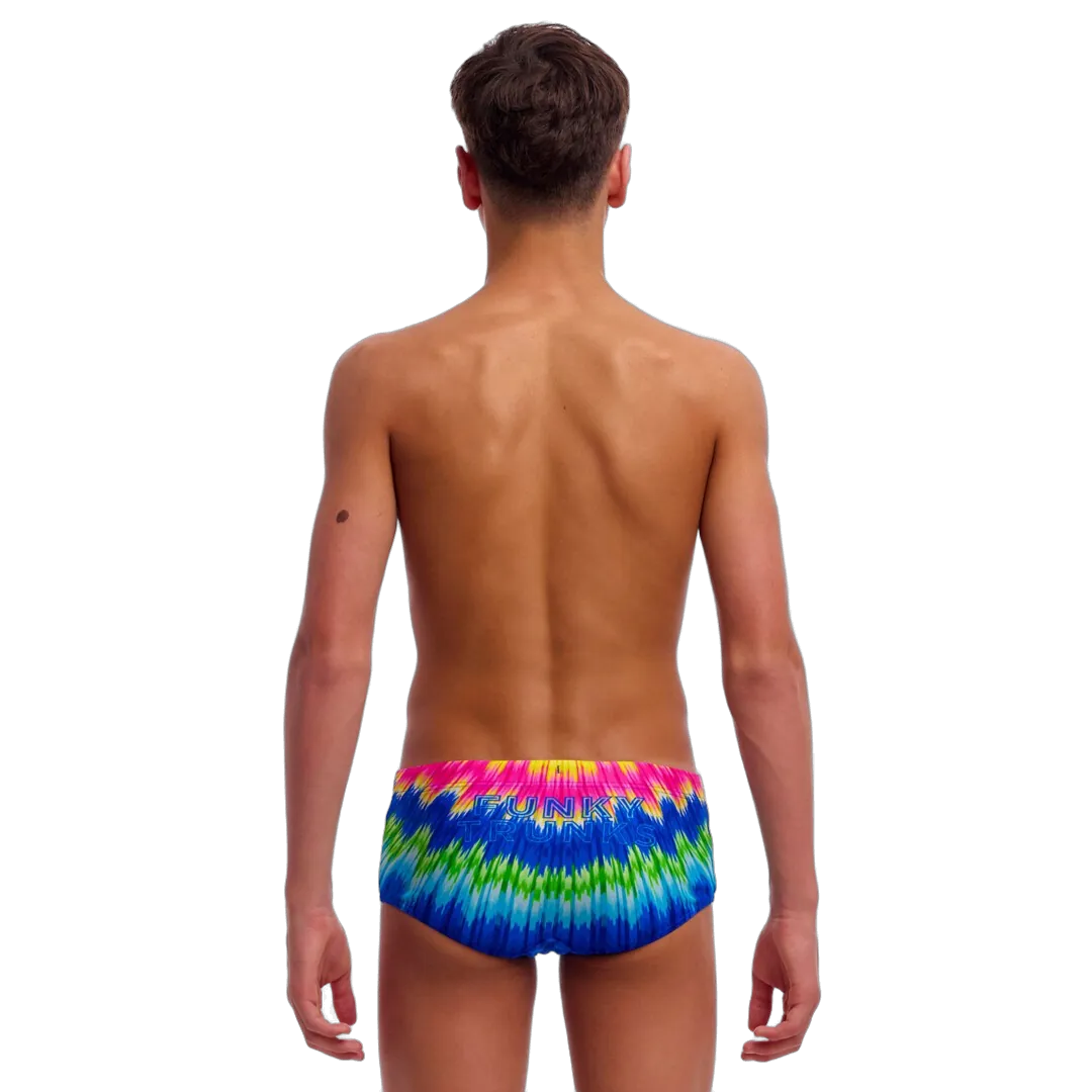 Boy wearing colourful tie-dye swimming trunks