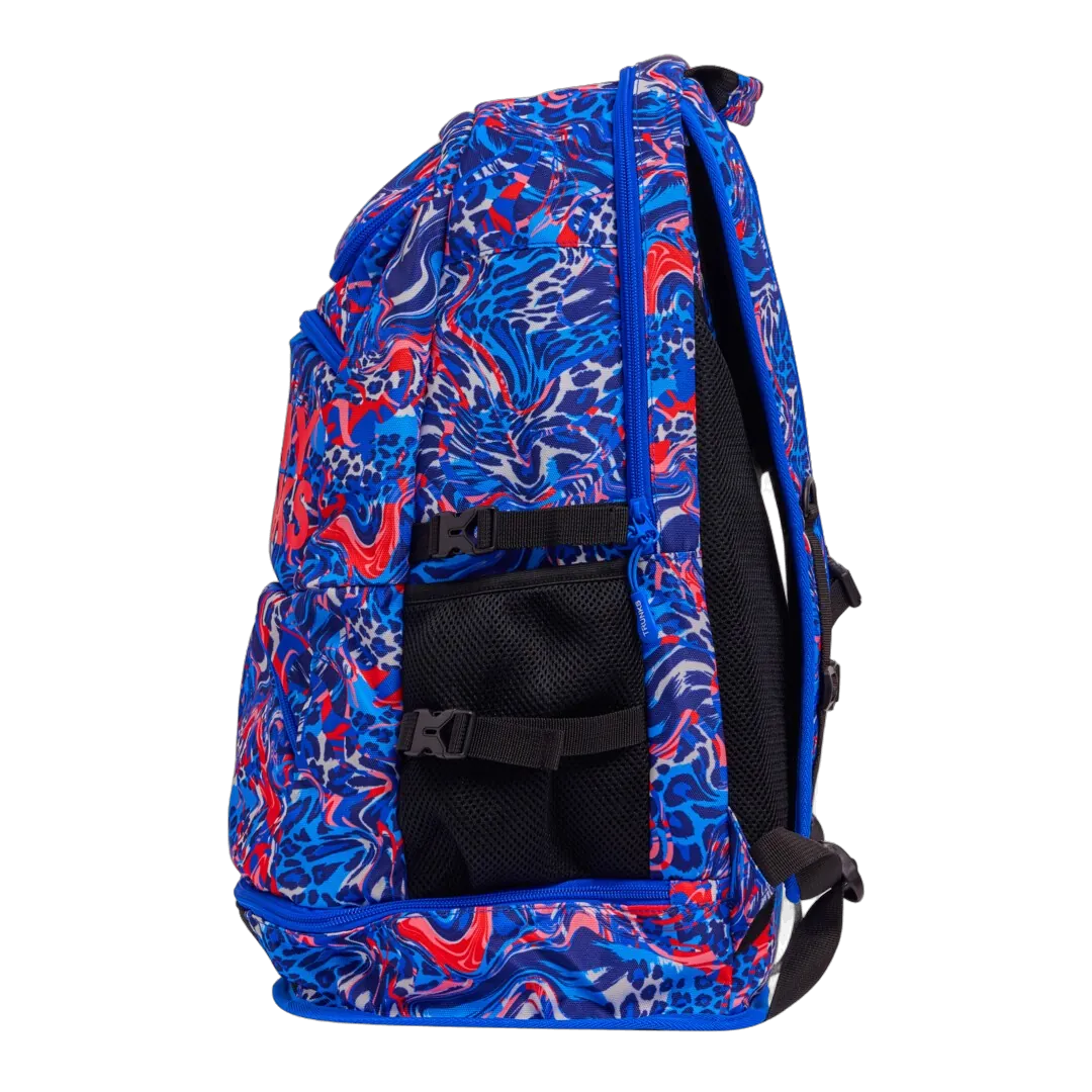 Blue and red patterned swimming backpack with 'Funky Trunks' branding from left side