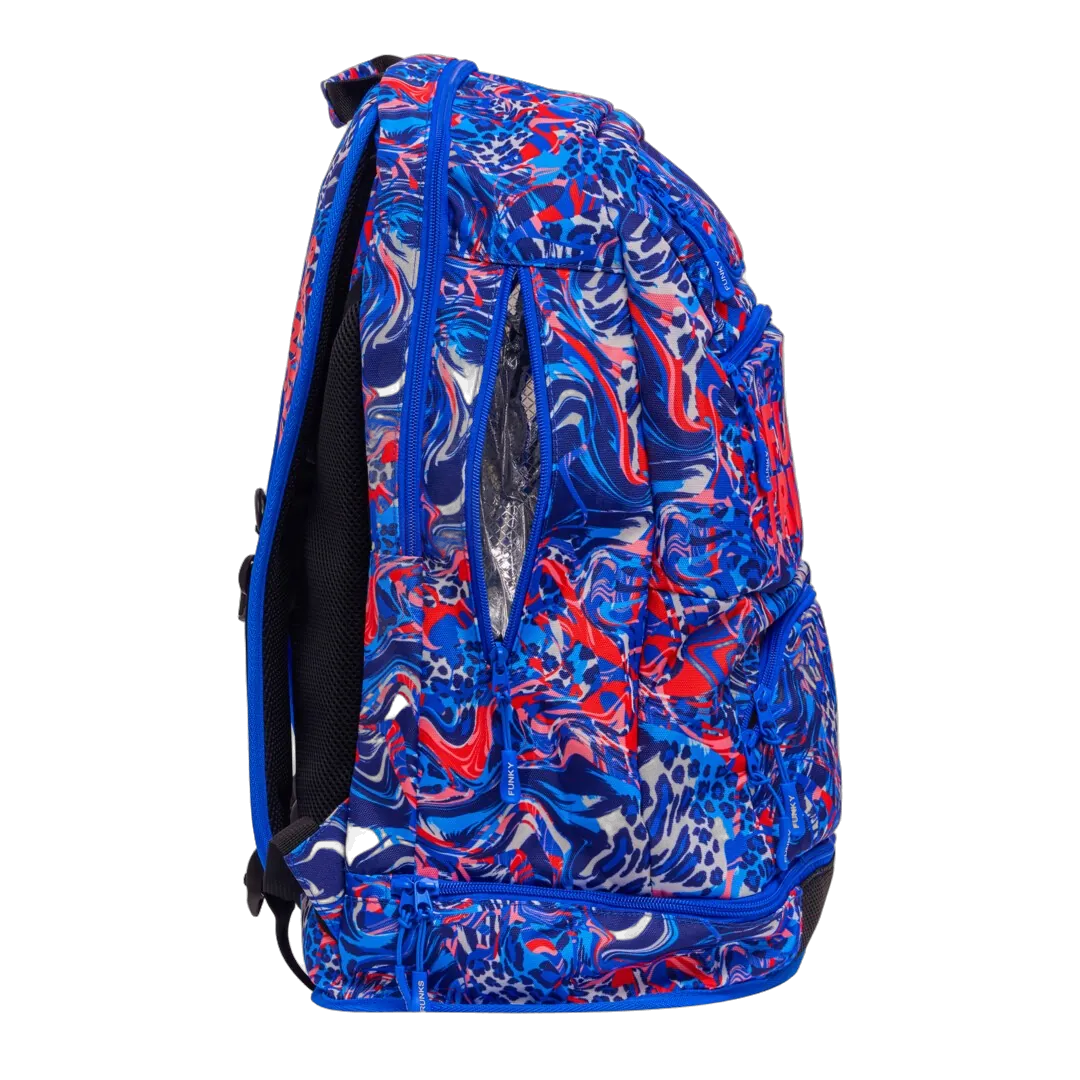 Blue and red patterned swimming backpack with 'Funky Trunks' branding from right side