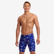 A shirtless male model wearing blue swimming jammers with a white "scratchy" pattern from Funky Trunks 