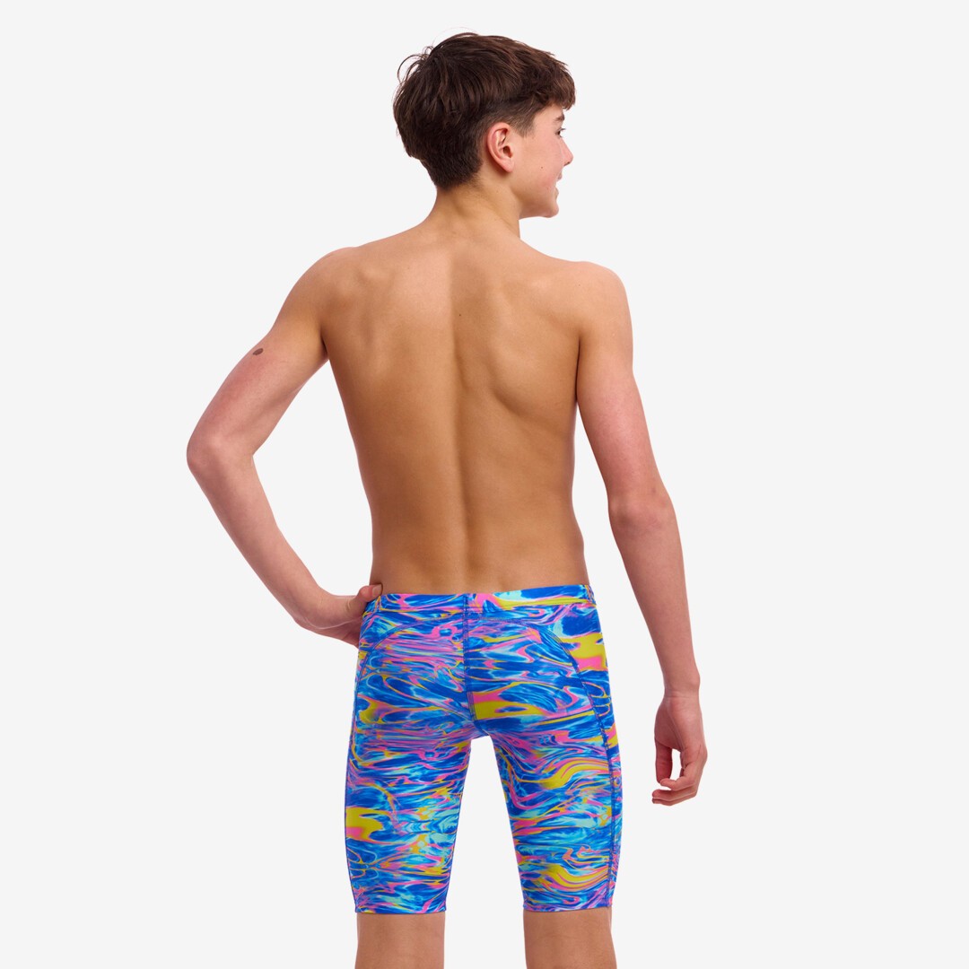 A boy wearing Funky Trunks Stir Crazy jammers - back view