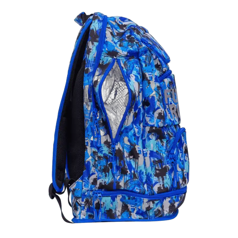 Blue and black patterned backpack with 'Funky Trunks'  branding and right side pockets open