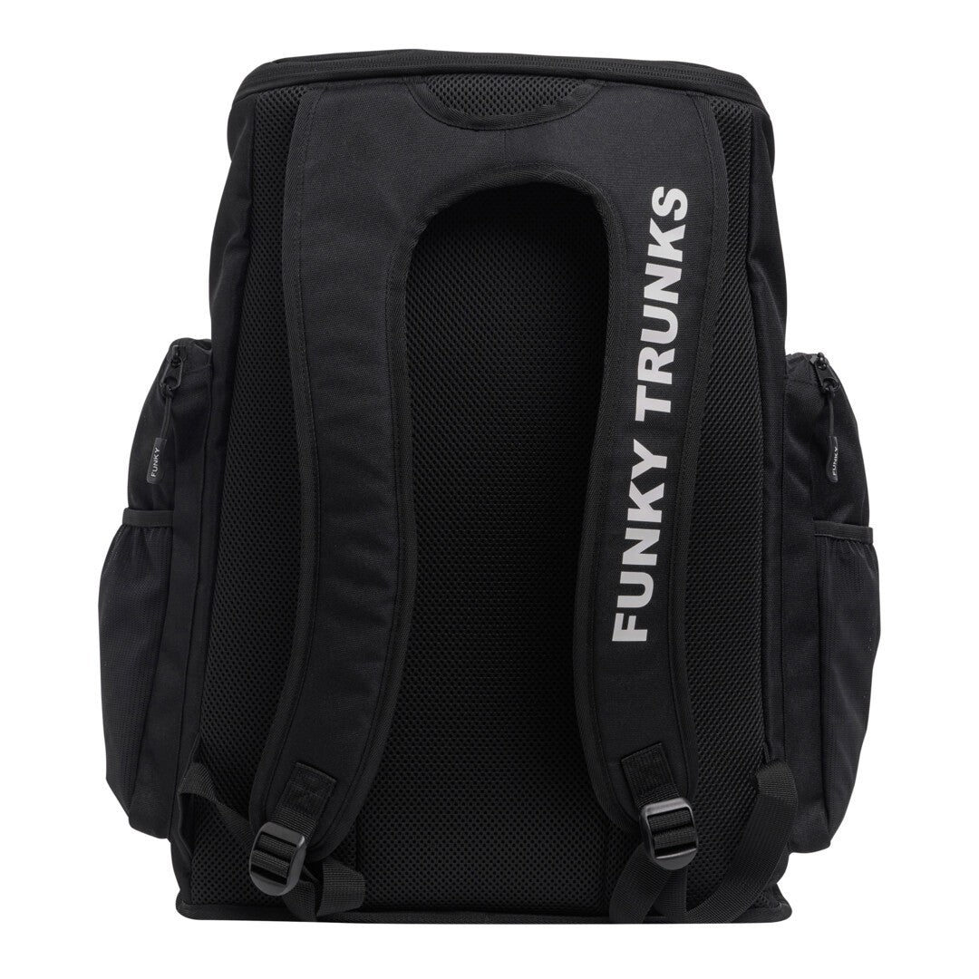 Back view of a black swimming backpack with 'Funky Trunks' text on the shoulder straps on a white background