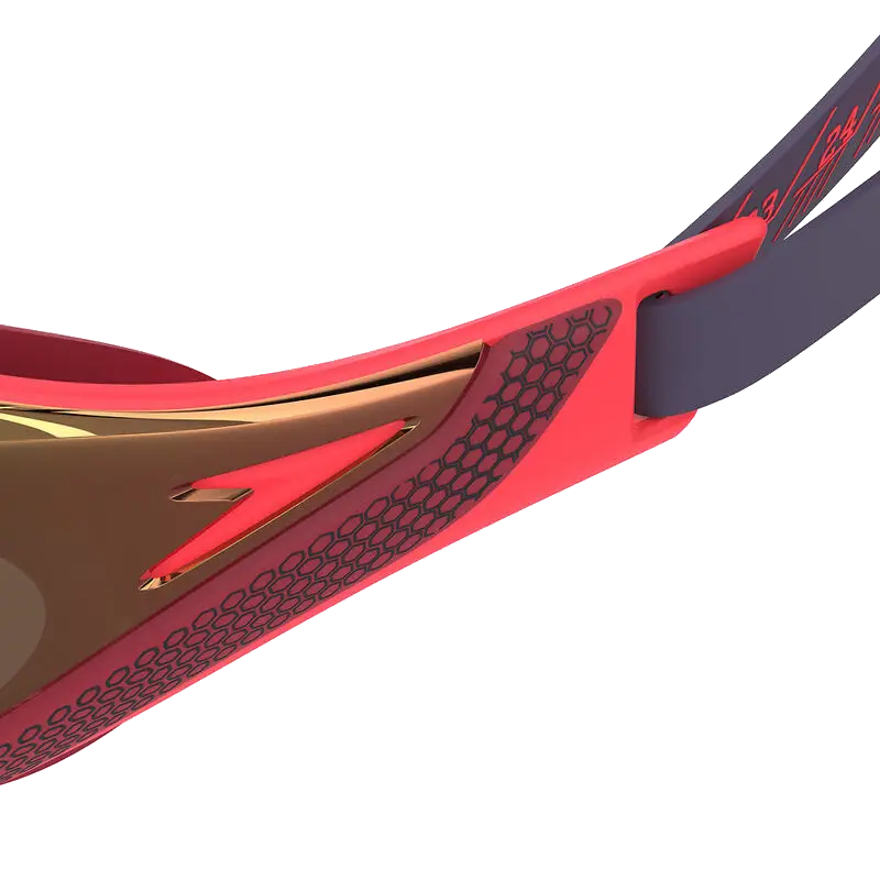 Close-up of autumn red smoke speedo fastskin pure focus goggles with a dark gray strap, showing the temple arm, textured grip, and part of the lens on a white background.