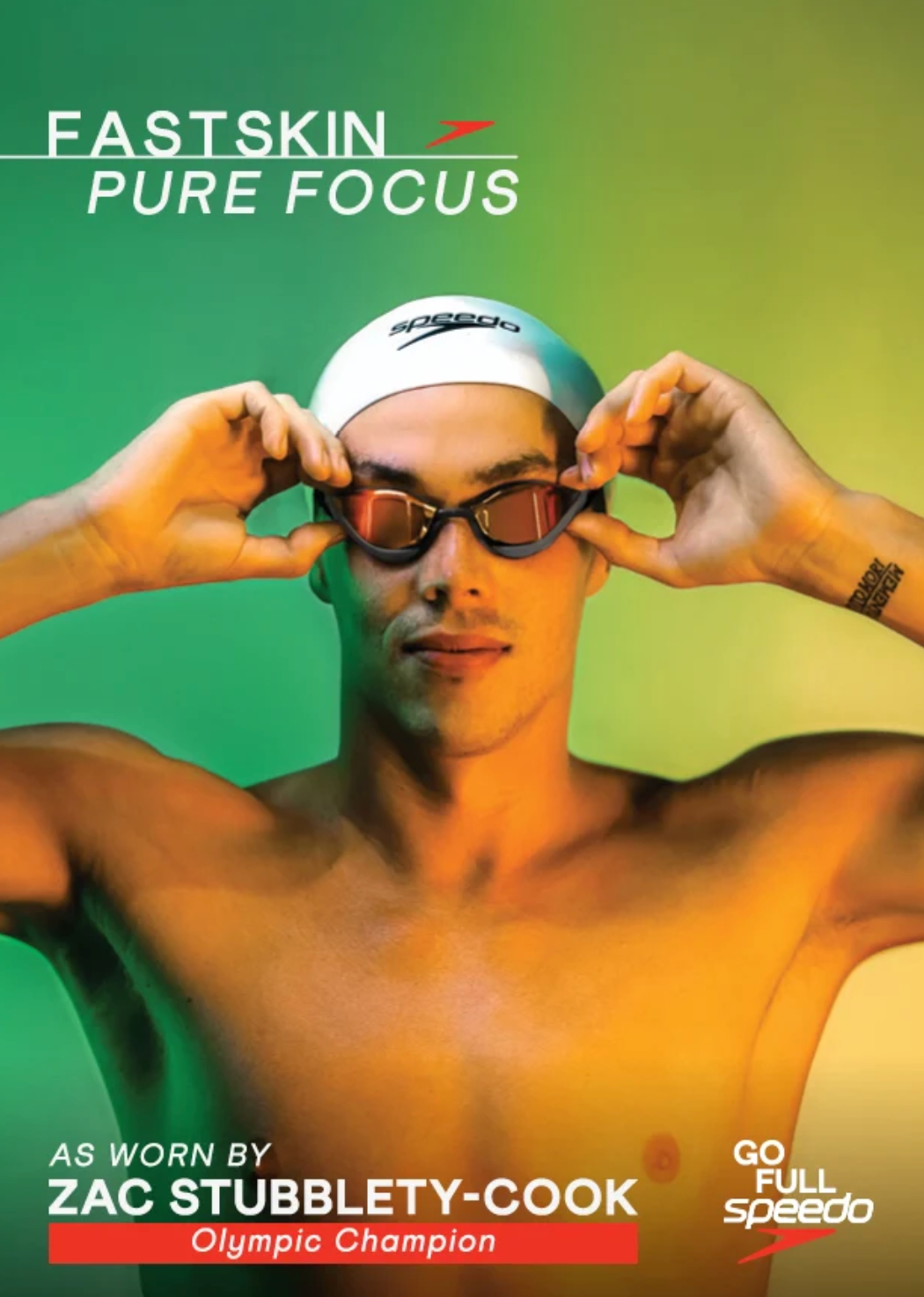Promotional swimwear image featuring a male swimmer in a white Speedo swim cap and dark swim goggles, with the text 'FASTSKIN PURE FOCUS' at the top and 'AS WORN BY ZAC STUBBLETY-COOK Olympic Champion' at the bottom on a green gradient background.