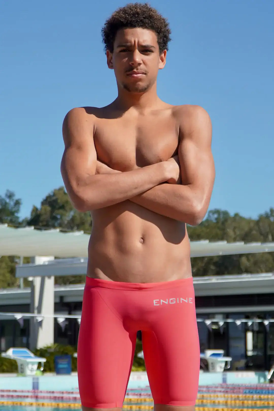Man wearing ice-lolly coloured swim trunks with 'Engine' branding.