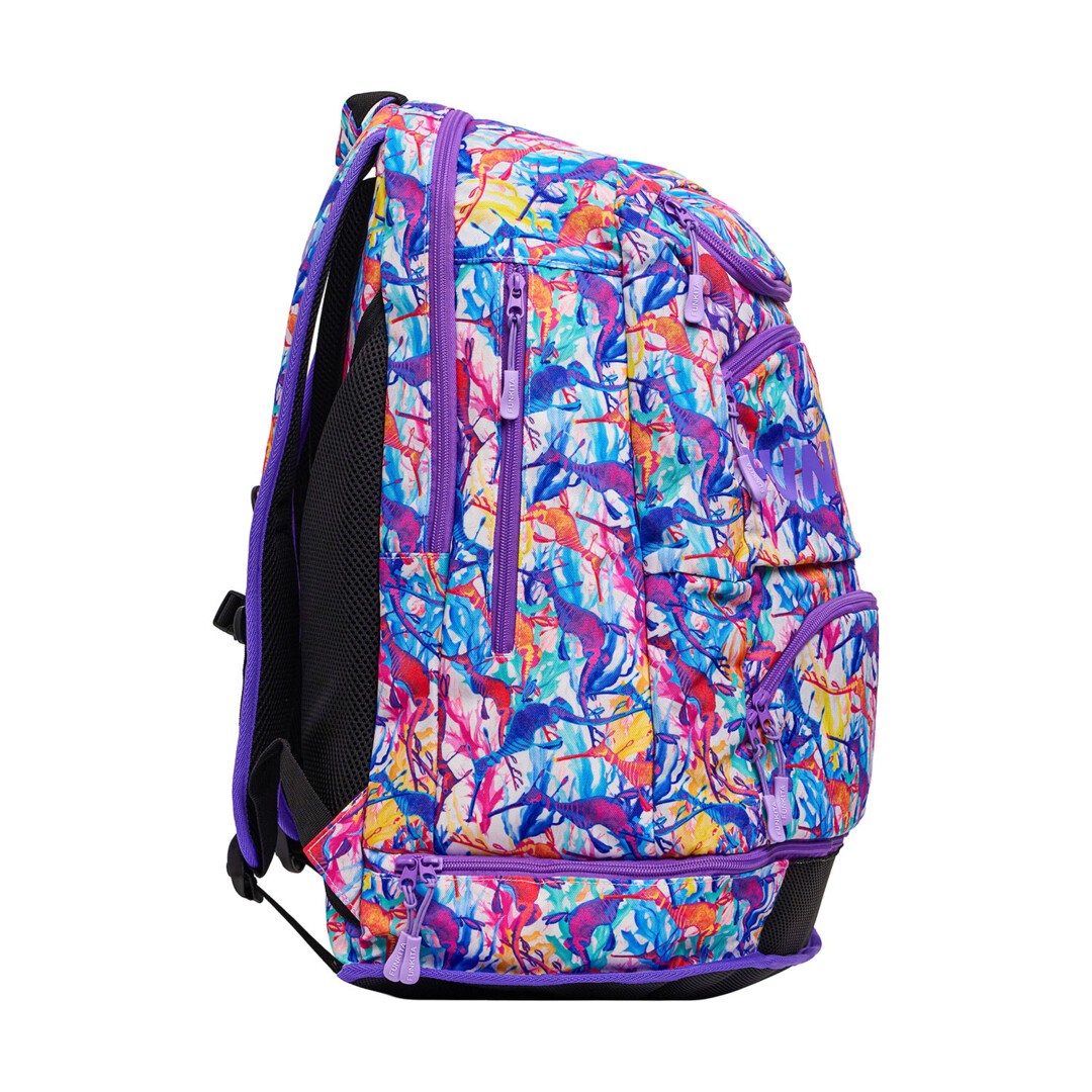 Side view of a colourful backpack with a vibrant pattern, multiple zips and purple 'Funkita' branding on a white background