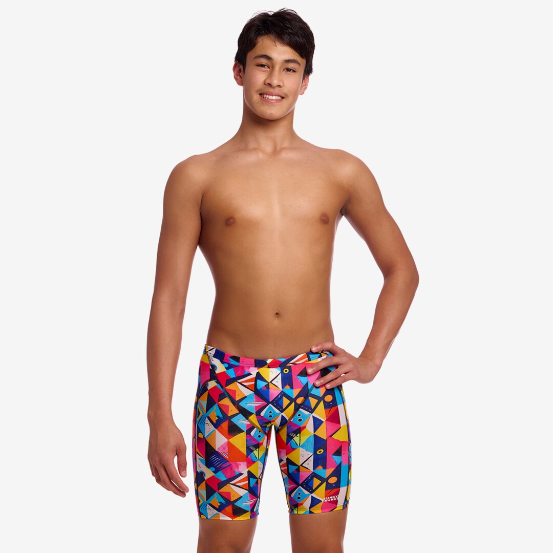 Person wearing colourful geometric patterned swim jammers on a white background
