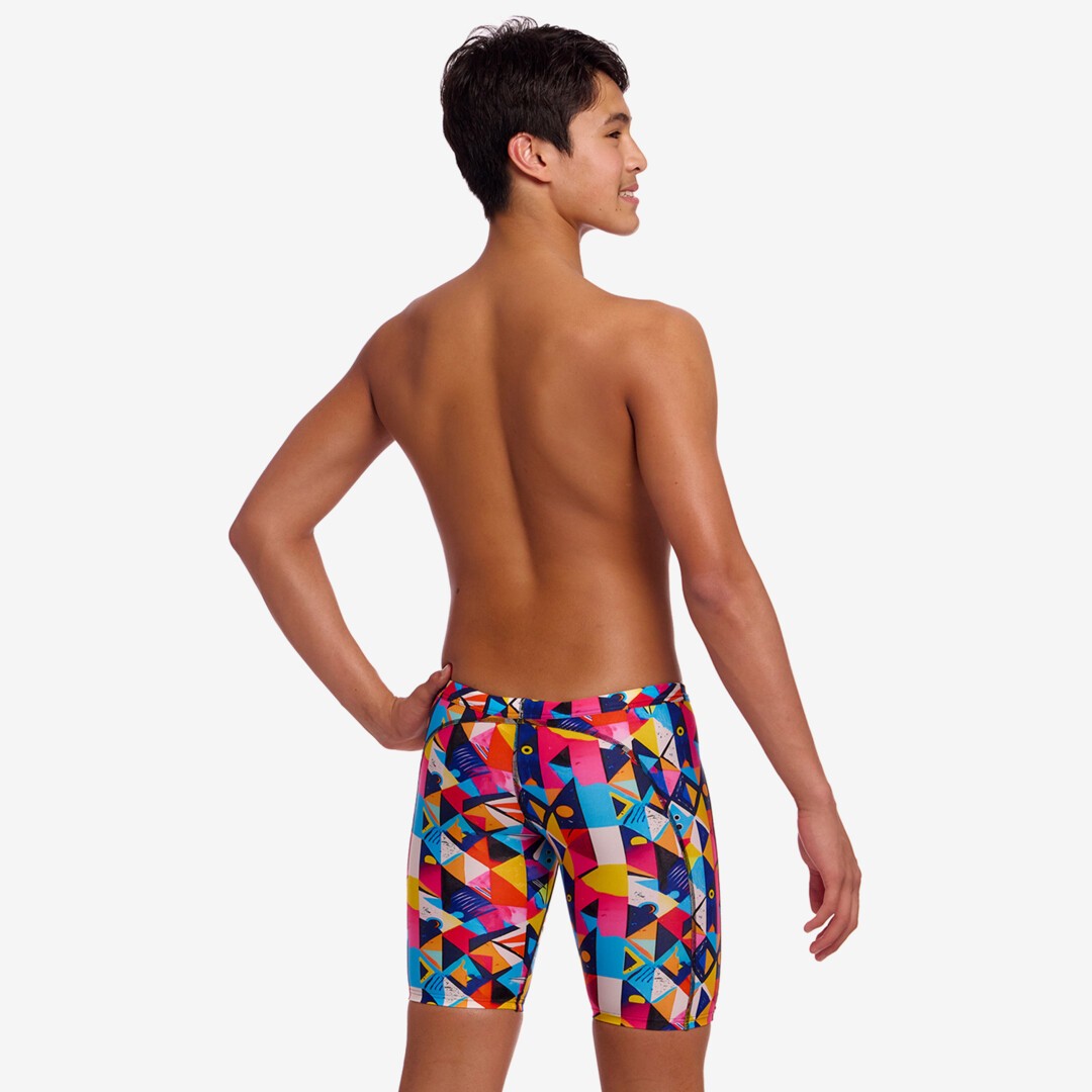 Back view of a person wearing colourful geometric-patterned swim jammers on a white background