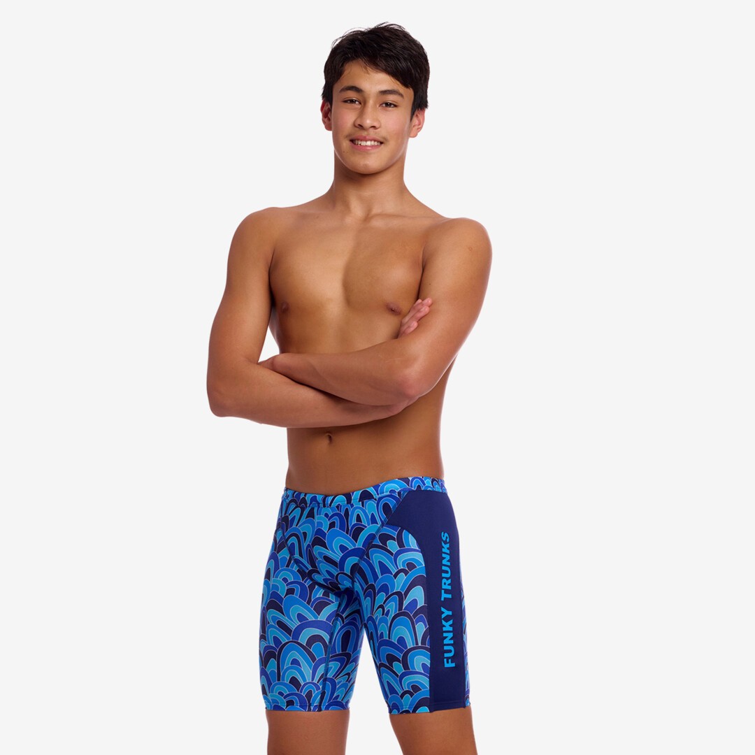 Person wearing blue swim jammers with a blue wave pattern on a white background