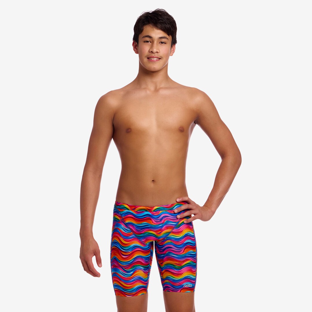 Person wearing colourful wave patterned swim jammers on a white background