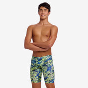 Male wearing colourful swim jammers on a white background