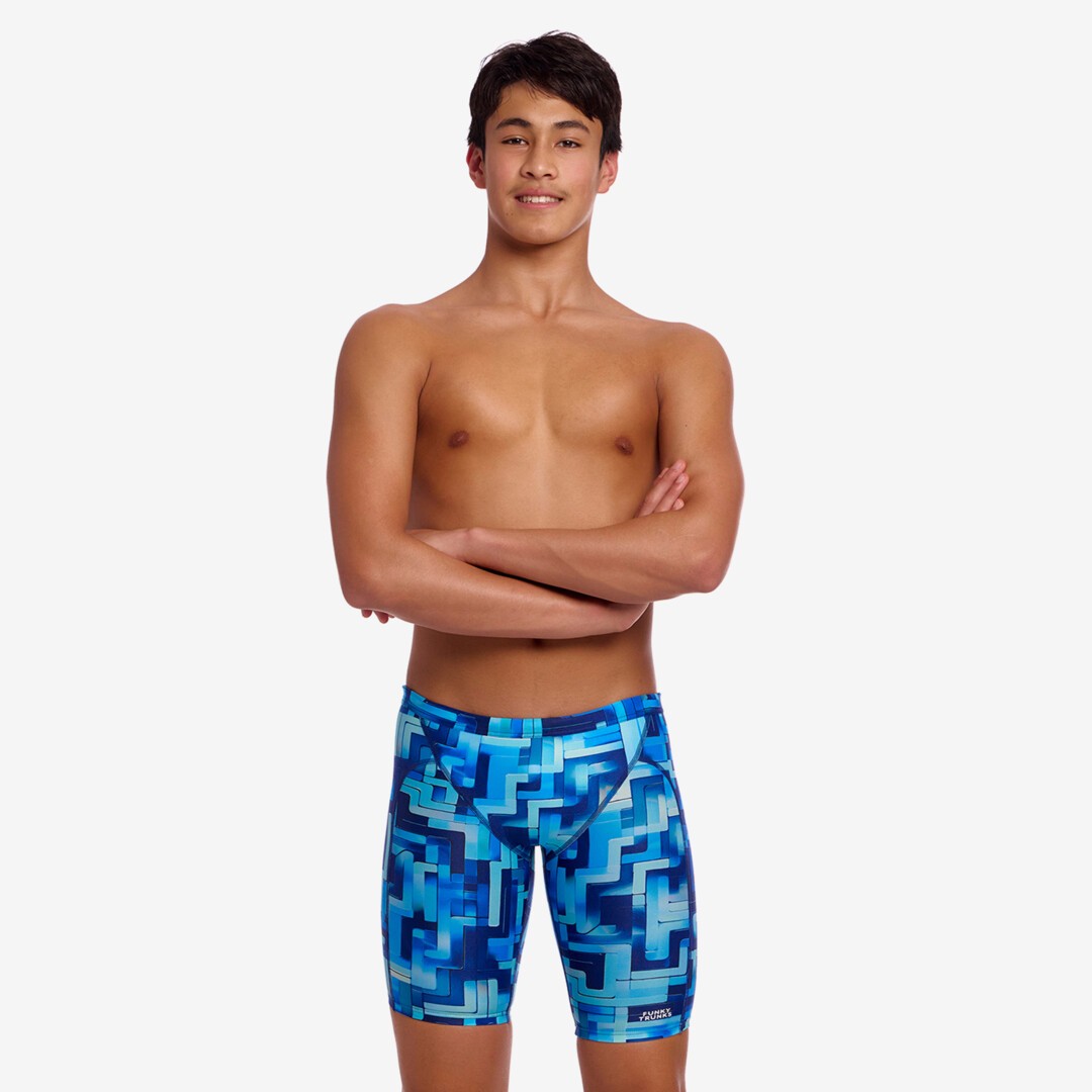 Person wearing blue swim jammers with geometric pattern on a white background