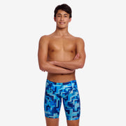 Person wearing blue swim jammers with geometric pattern on a white background