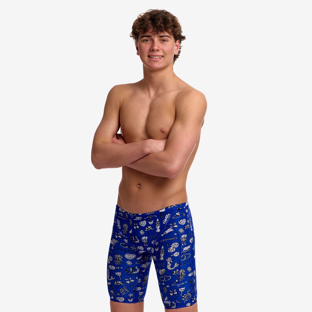 A young man modelling blue patterned swim jammers with a "scratchy" pattern in white from Funky Trunks.