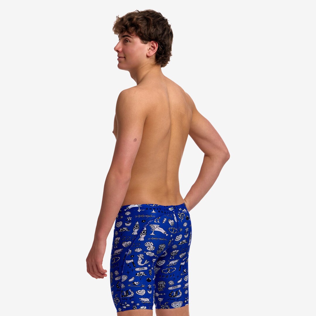 A young man shown form the back modelling blue patterned swim jammers with a "scratchy" pattern in white from Funky Trunks.
